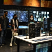 Dos personas interactuando con la mediadora del Museo del Espacio. 