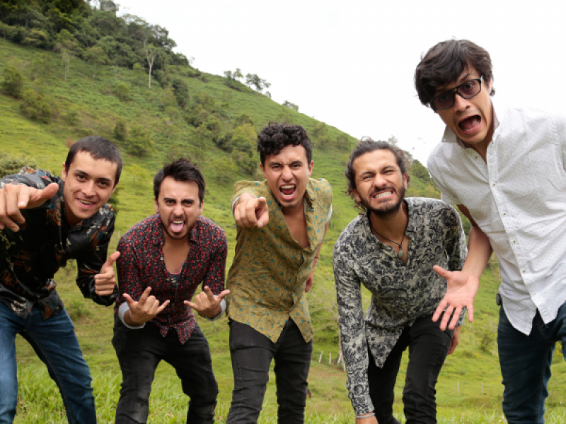 Hombres posando para la cámara en un espacio verde de montaña