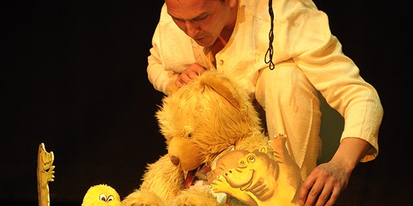 Actor en escena con oso de peluche